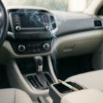 Zigarette liegt im Aschenbecher im Auto und der Rauch verteilt sich